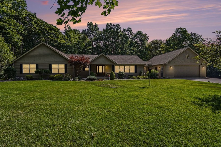Twilight front exterior of the ranch home and attached garage at 6333 Blackmar Road