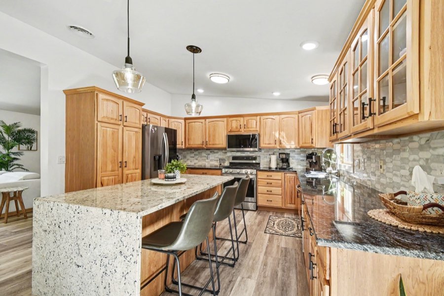Renovated kitchen with center island, wood cabinetry, and stainless appliances