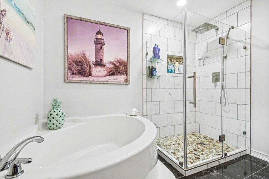 Full bathroom with tiled shower and soaking tub