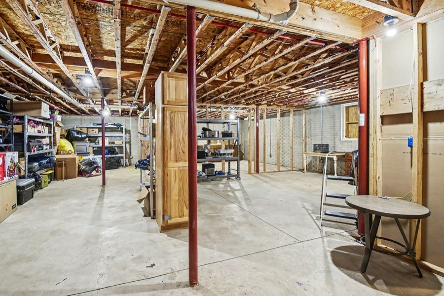Open unfinished basement with concrete floor and exposed ceiling